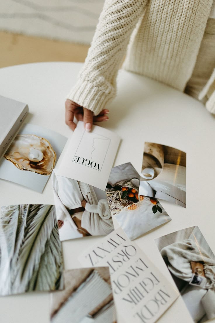 Moodboard of brand photography and editorial reference prints on a studio table
